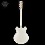 White electric guitar on a black background with 'Tone Shop' logo.