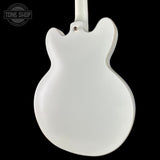 White electric guitar body on a black background with 'Tone Shop' logo.