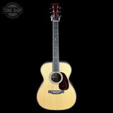 Acoustic guitar with a visible brand logo on a white background