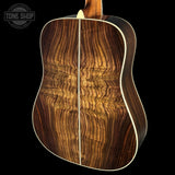 Wooden acoustic guitar with a visible brand logo in the corner