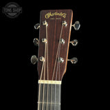Guitar headstock with Martin & Co logo on a black background