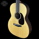 Acoustic guitar with a visible brand logo on a black background