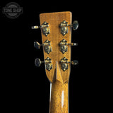 Close-up of a guitar headstock with tuning pegs on a black background, featuring the Tone Shop logo.