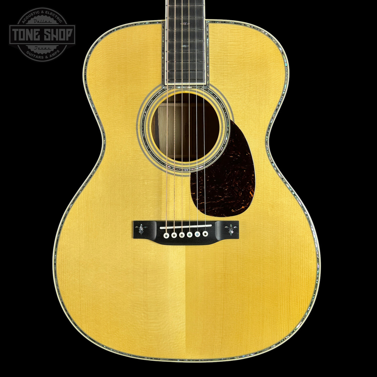 Acoustic guitar with a visible brand logo in the corner