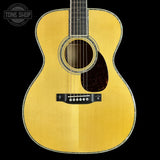 Acoustic guitar with a visible brand logo in the corner