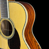Close-up of an acoustic guitar with a focus on the soundhole and wooden body.