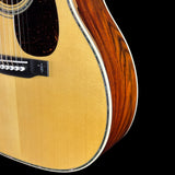 Close-up of an acoustic guitar with a focus on the body and neck.