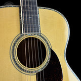 Close-up of an acoustic guitar with a black background