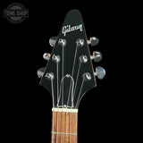 Gibson guitar headstock with brand logo on a black background