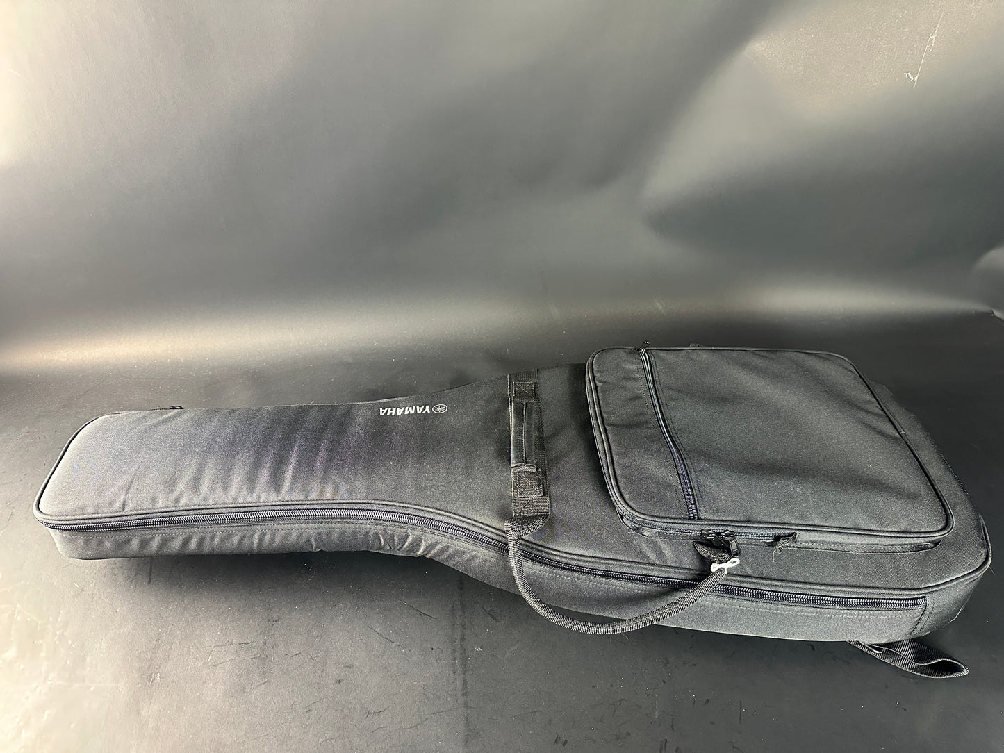 Gray guitar case on a reflective surface