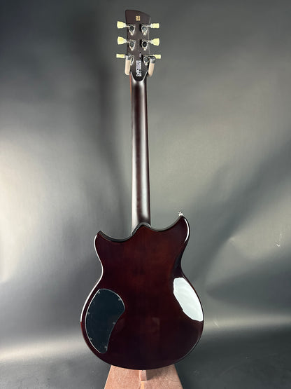 Guitar headstock and neck on a gray background