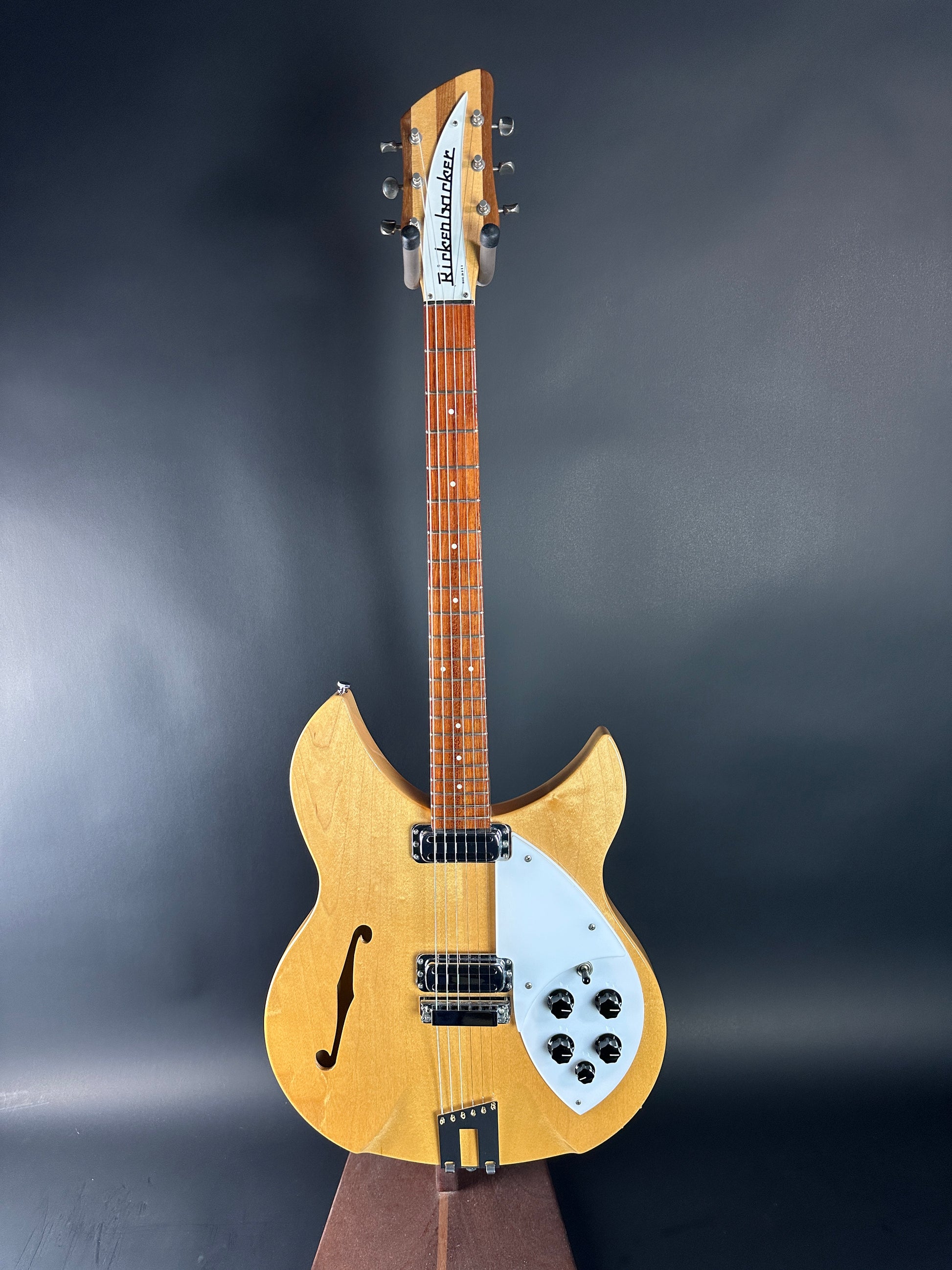 Wooden electric guitar on a dark background