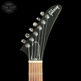 Gibson guitar headstock with brand logo on a black background