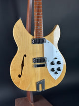 Electric guitar with a wooden body and neck on a dark background