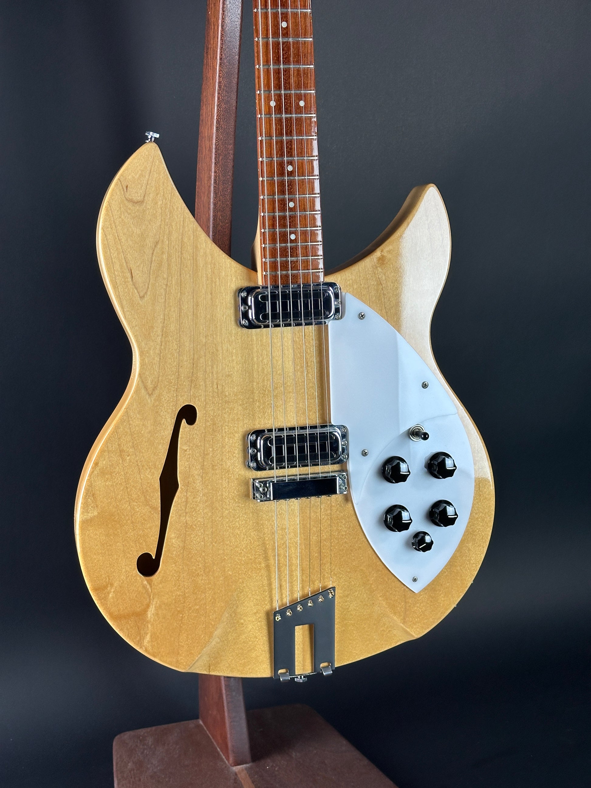 Electric guitar with a wooden body and neck on a dark background