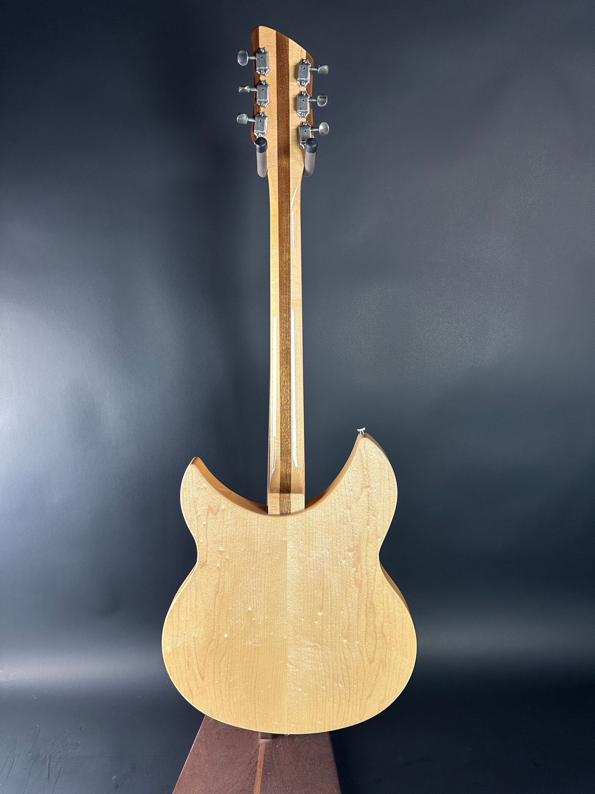 Wooden electric guitar on a dark background