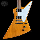 Gibson Explorer guitar with a white pickguard on a black background, featuring the Tone Shop logo.