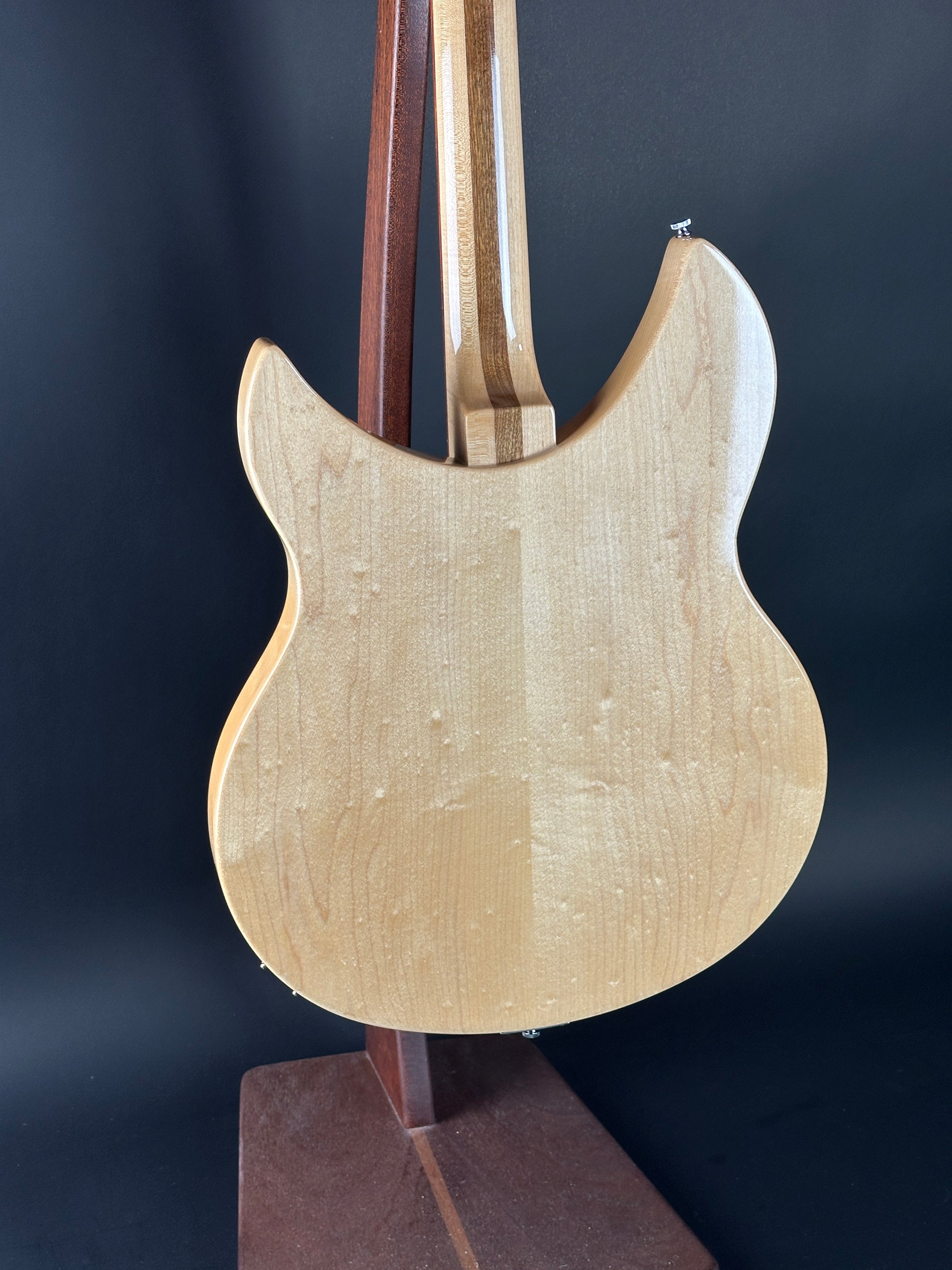 Close-up of a wooden guitar body on a dark background