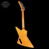 Wooden electric guitar body on a black background with 'Tone Shop' logo.