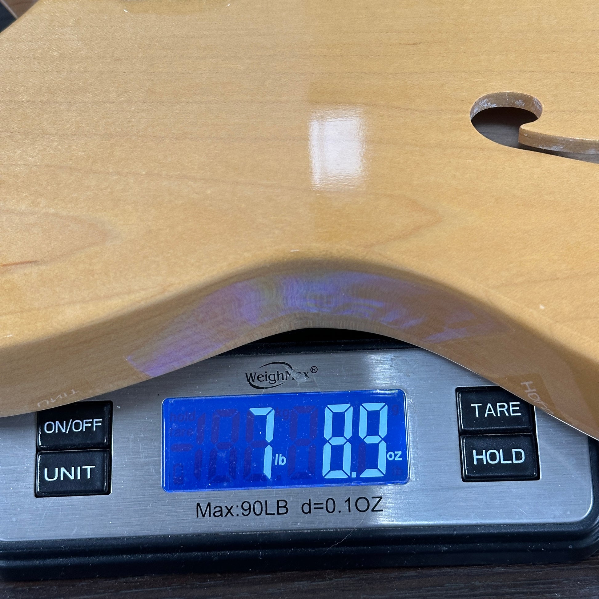 Digital scale displaying weight on a wooden surface