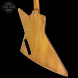 Wooden guitar body with a black pickguard on a black background, featuring 'Tone Shop' logo.