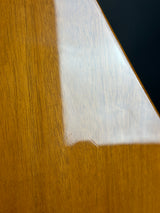 Close-up of a wooden surface with a white triangle and black area.