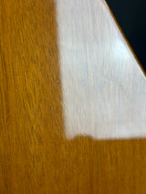Close-up of a wooden surface with a white rectangular object on top