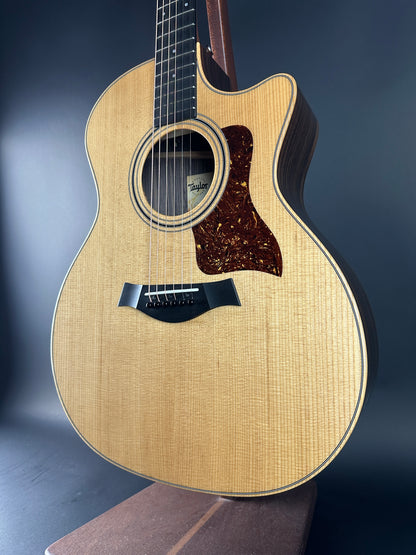 Acoustic guitar with a natural wood finish on a dark background