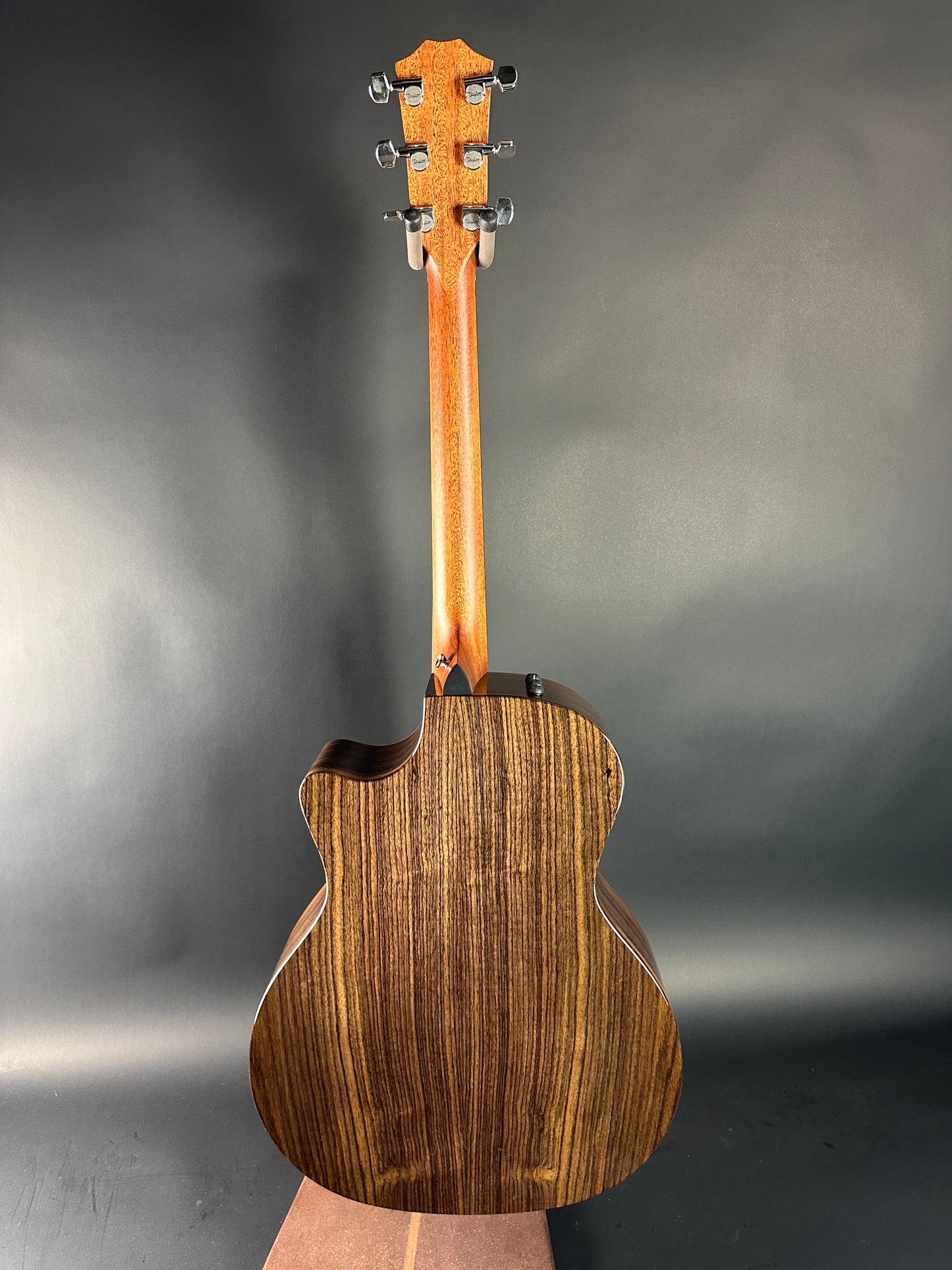 Wooden acoustic guitar on a gray background