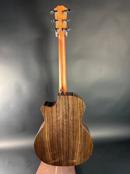 Wooden acoustic guitar on a gray background