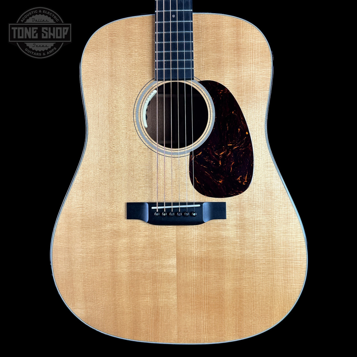 Acoustic guitar with a visible brand logo in the corner
