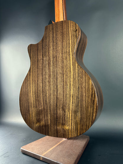 Close-up of a wooden guitar body on a gray background