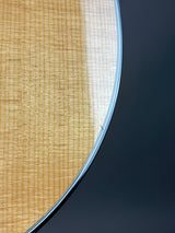 Close-up of a guitar's soundboard with a dark background