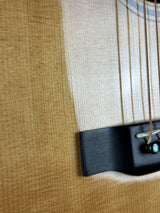 Close-up of a guitar's soundhole with a pick on a textured surface