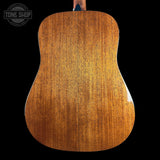Back of a wooden acoustic guitar with 'Tone Shop' logo in the corner.