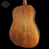 Back view of a wooden acoustic guitar with 'Tone Shop' logo.
