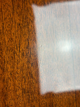 Close-up of a wooden surface with a glass overlay