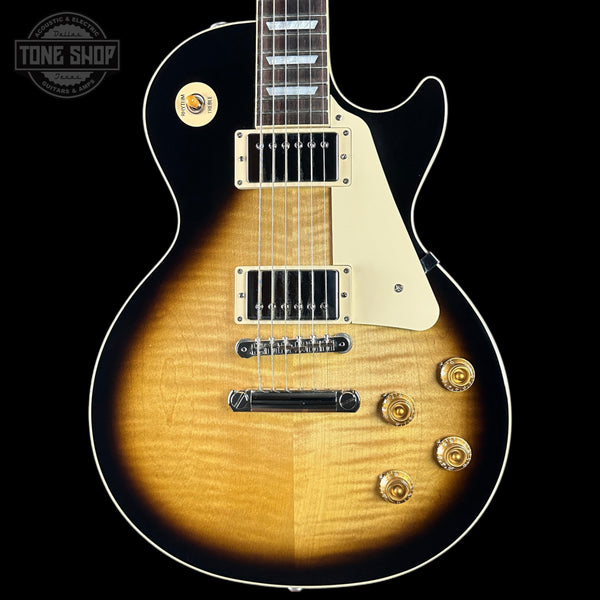 Electric guitar with a sunburst finish on a black background, featuring the Tone Shop logo.