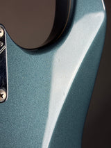 Close-up of a metallic blue object with a dark background