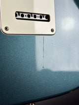 Close-up of a guitar pickup cover on a guitar body