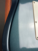 Close-up of a textured surface with a metallic plate and brown element.