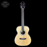 Acoustic guitar on a black background with 'Tone Shop' logo.