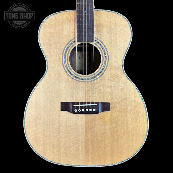 Acoustic guitar with a visible brand logo on a black background