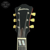 Guitar headstock with Eastman branding on a black background