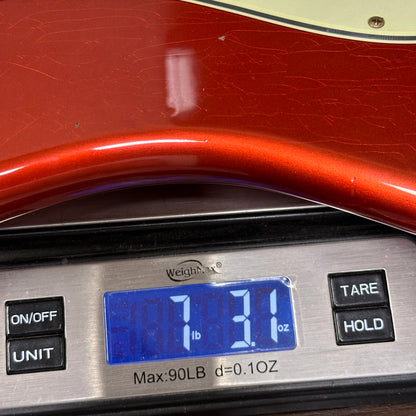Digital scale displaying weight with a red object on top