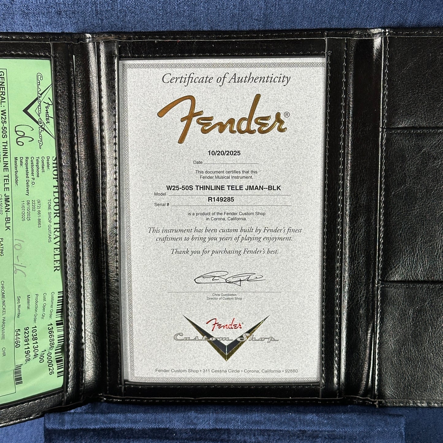 Fender certificate of authenticity in a leather case on a blue background