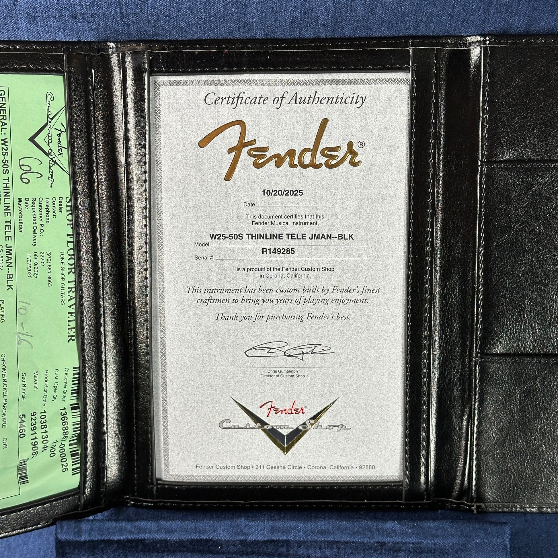 Fender certificate of authenticity in a leather case on a blue background