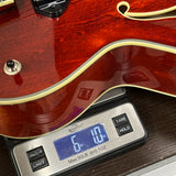 Gibson Les Paul guitar on a digital scale showing weight