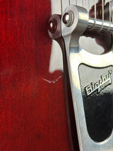 Close-up of a guitar's bridge and tuning pegs with 'Biagio' branding.