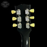 Guitar headstock with tuning pegs on a black background, featuring the Tone Shop logo.